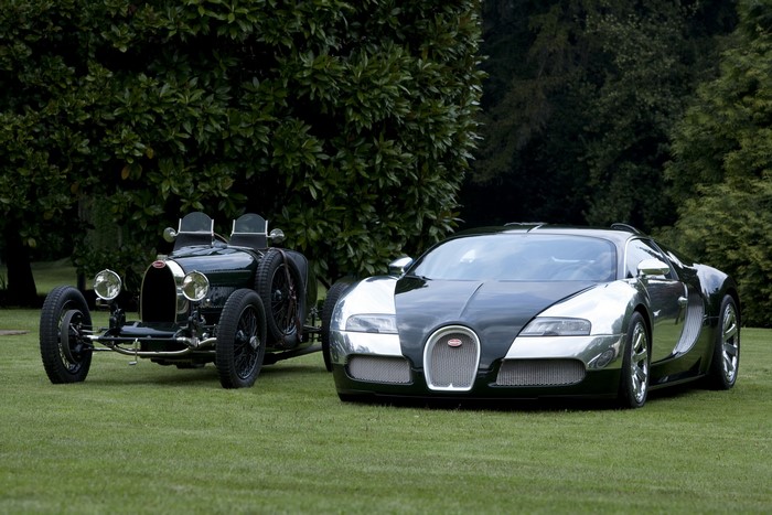 Bugatti Veyron and vintage Bugatti car on grass