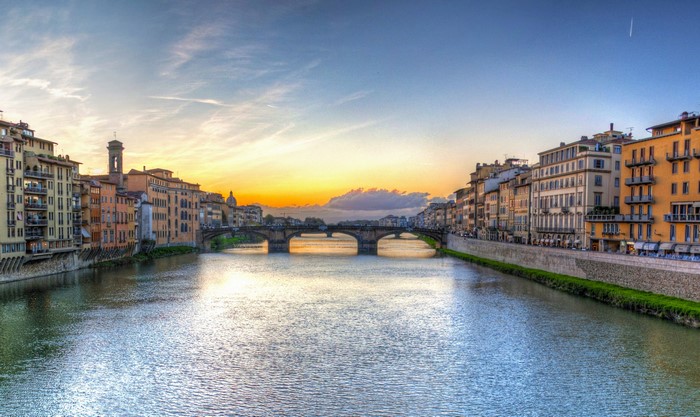 Ponte Vecchio bridge over Arno River in Florence, Italy at sunset