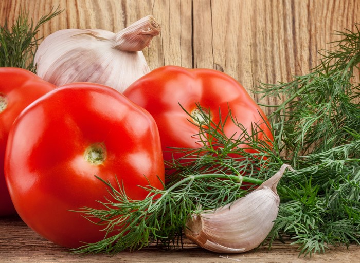 4K Tomatoes, Garlic, and Dill on Wood