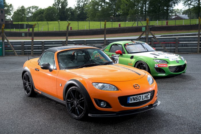 Two Mazda MX-5 GT cars on a wet race track