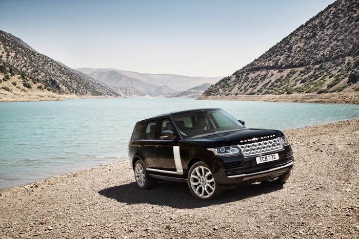 Black 2013 Range Rover by a lake