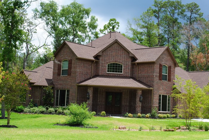 Brick Mansion with Green Lawn and Trees