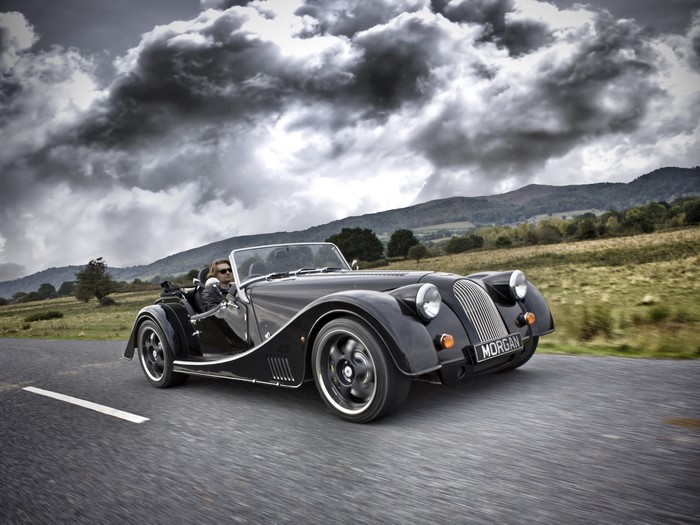 Black 2012 Morgan Plus 8 Cabriolet driving on a road