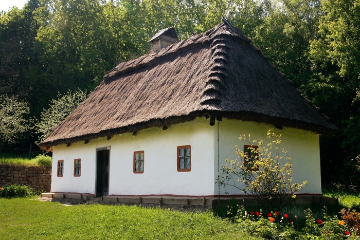 Traditional white house with thatched roof