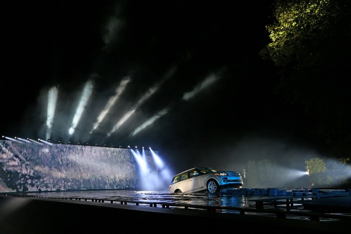2013 Range Rover driving through water at night