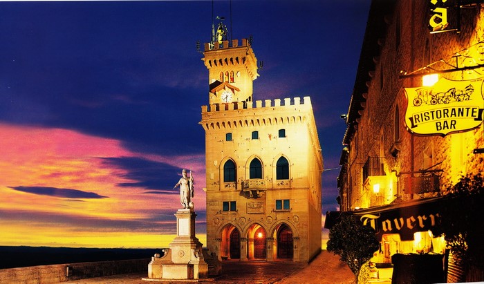 Palazzo Pubblico and statue in San Marino at dusk