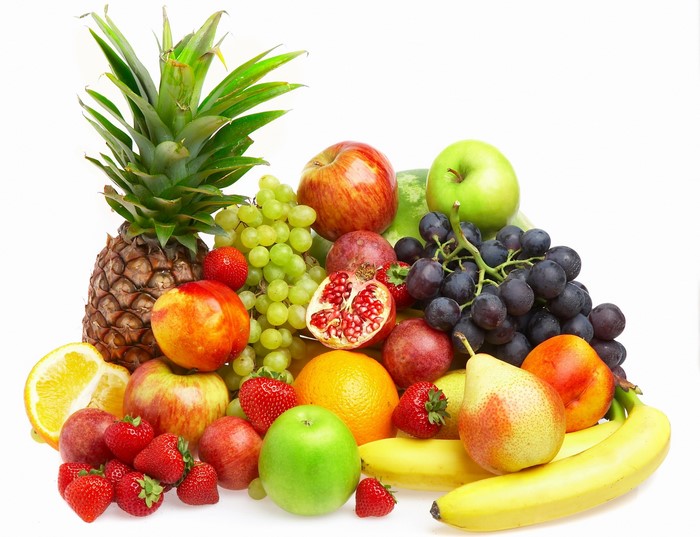 Assortment of fresh fruits including pineapple, grapes, apples, strawberries, bananas, and oranges