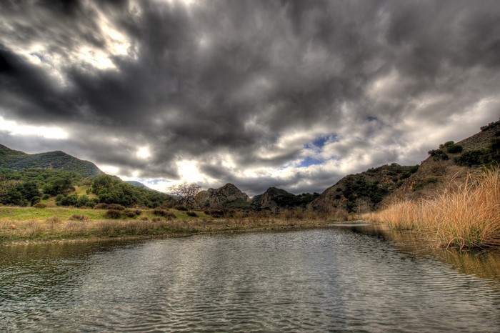 Lake and Mountains under Stormy Sky in Malibu, California