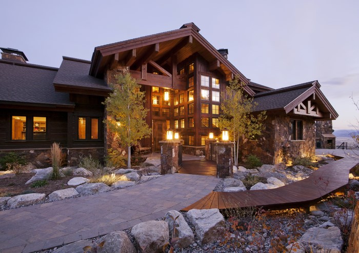 Luxury wooden mansion with stone exterior and landscape design