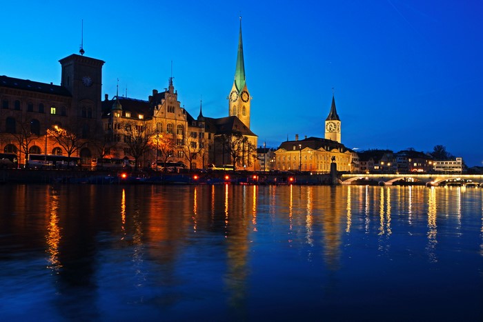 Zurich skyline with churches and river at night