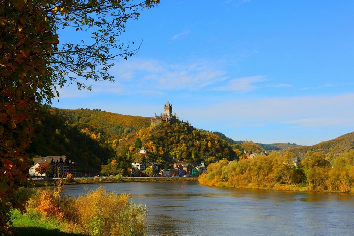 Cochem Castle overlooking the Moselle River in Germany during autumn