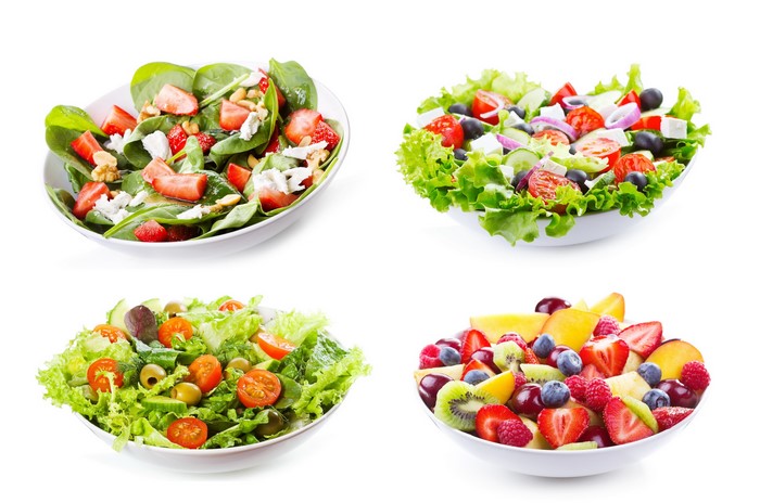 Four bowls of salads and fruit