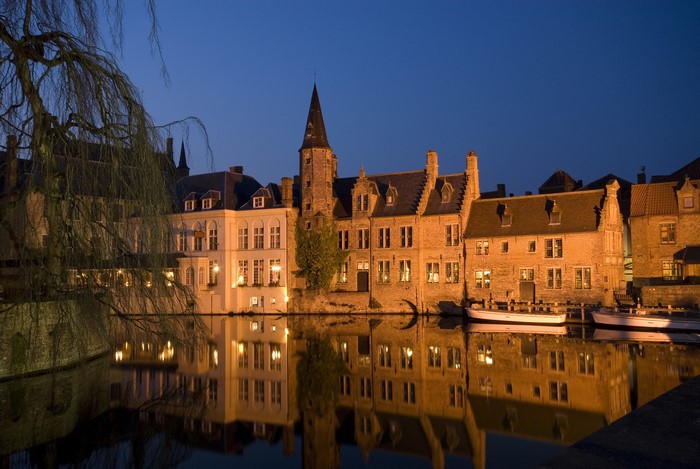 Bruges canal at night with historic buildings
