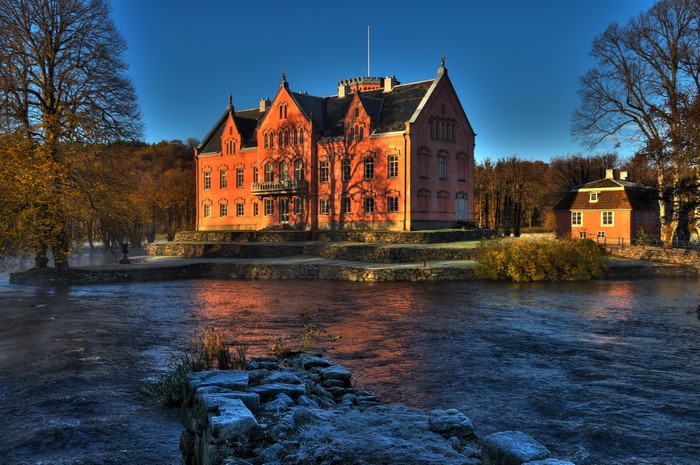 Orange castle by a river in Sweden