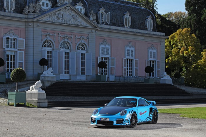 Light Blue Porsche 911 GT2 RS in front of a pink palace