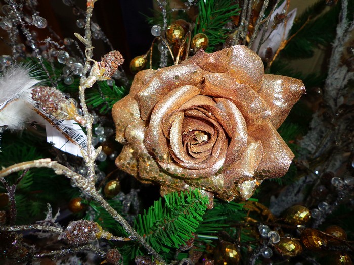 Gold rose ornament on a Christmas tree