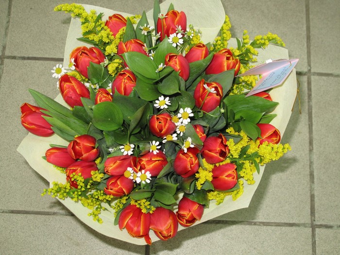 Bouquet of red tulips and yellow flowers