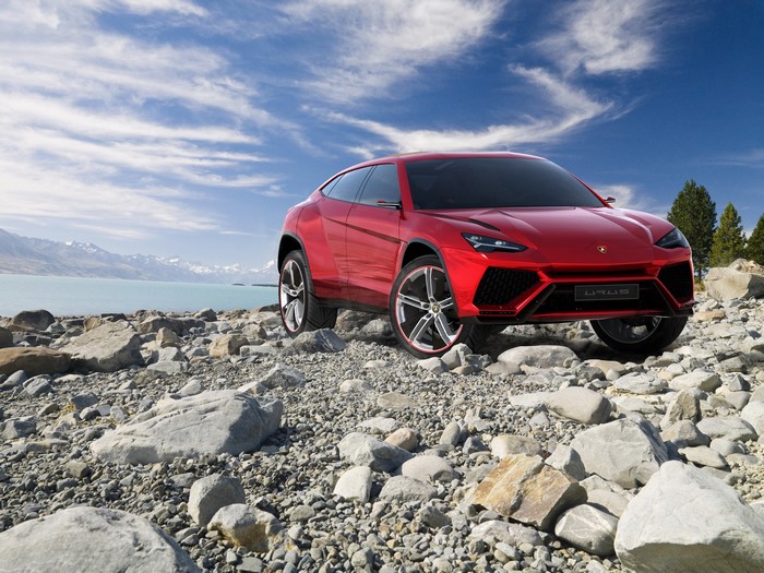 Red Lamborghini Urus on Rocky Shore