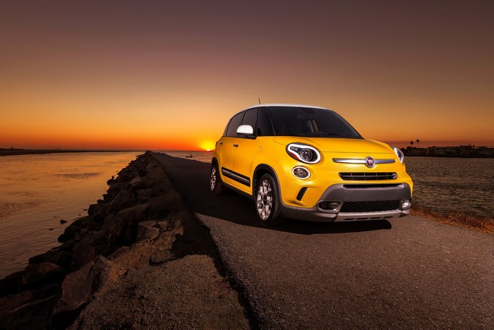 Yellow Fiat 500L Trekking on a road at sunset
