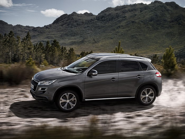 Grey Peugeot 4008 driving on a dirt road