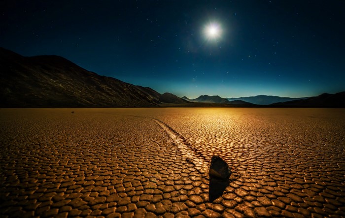 Moving rock on Death Valley Racetrack Playa at night