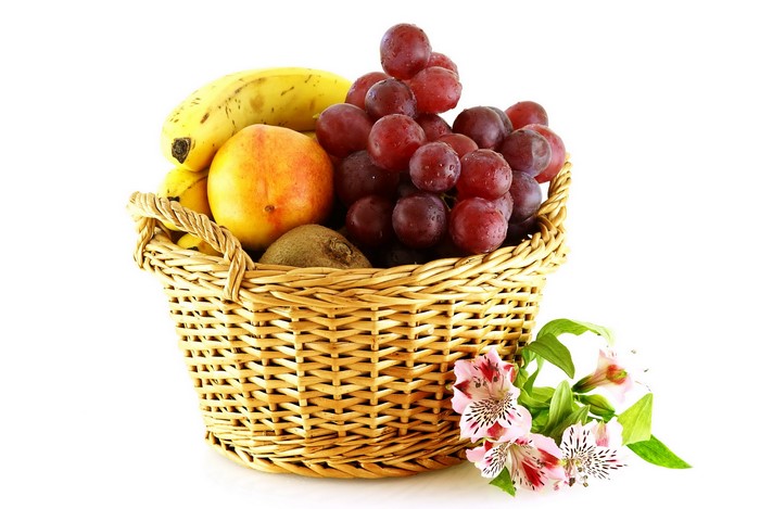 Fruit in a wicker basket with flowers