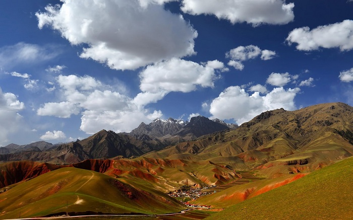 Mountain landscape with village and clouds