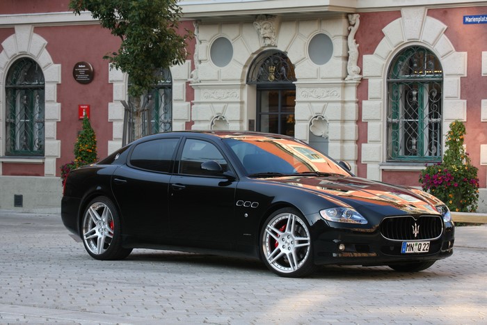 Black 2010 Maserati Quattroporte GTS parked in front of a building