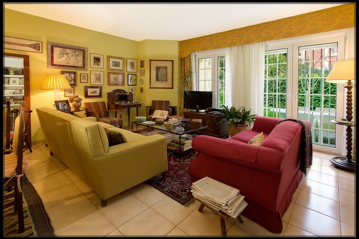 Living room with yellow walls and red sofa