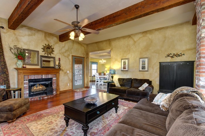 Living room with fireplace and exposed beams