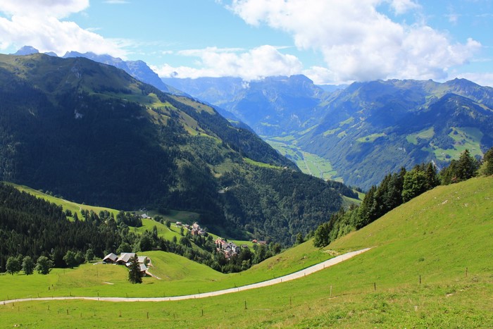 Alpine valley with mountains and a village in Switzerland