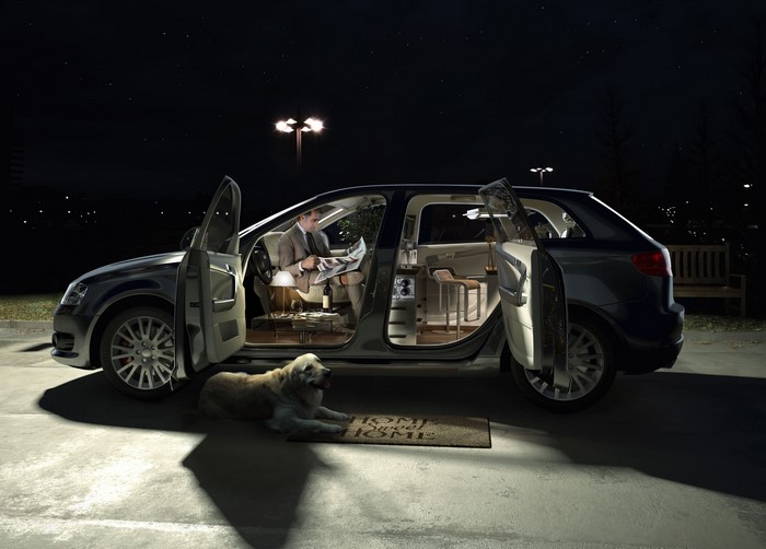 Man reading newspaper in car with dog at night