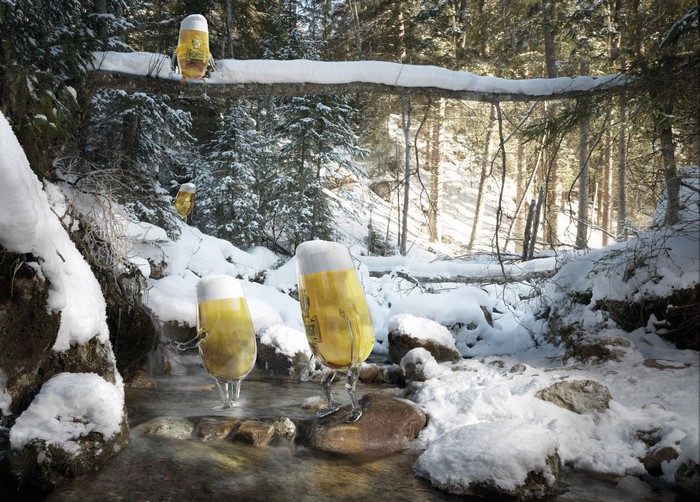 Beer glasses walking in a snowy forest stream