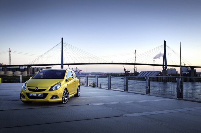 Yellow Opel Corsa OPC by a bridge