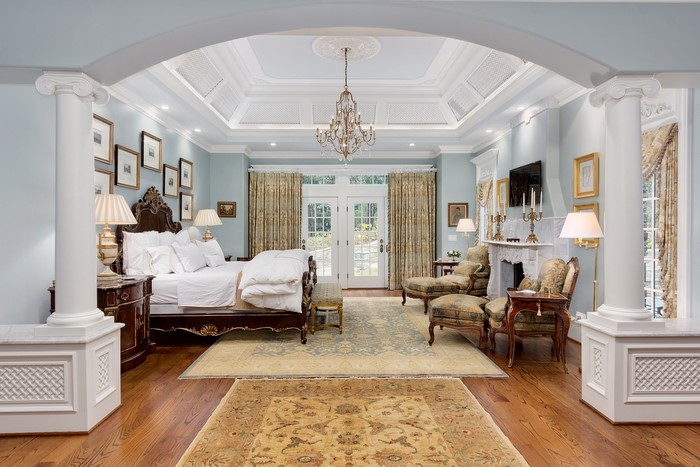 Elegant bedroom with chandelier and fireplace