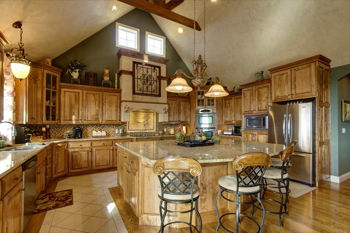Luxury wooden kitchen with island and bar stools