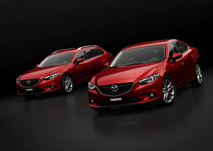 Two red Mazda 6 cars on a black background