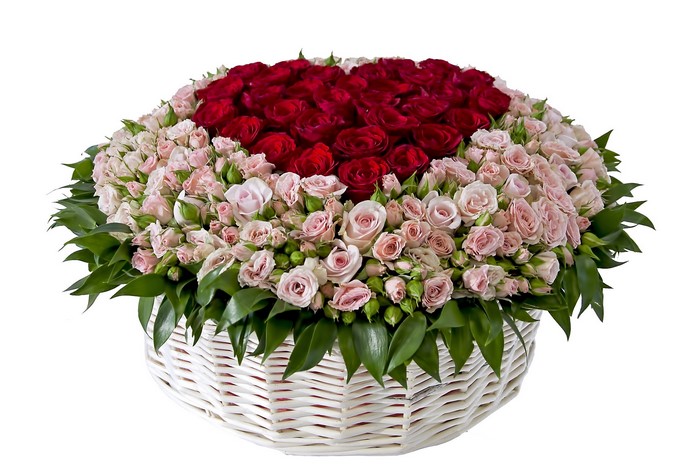 Heart-shaped bouquet of red and pink roses in a wicker basket