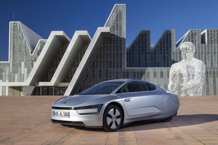2013 Volkswagen XL1 silver car in front of modern building