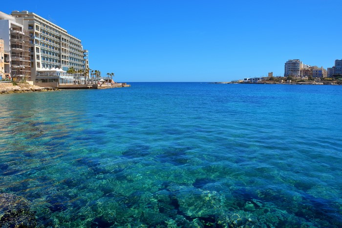 St. Julian's, Malta: Coastal view with clear blue sea and buildings