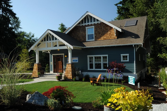 Craftsman style house with landscaping