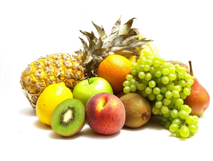 Assortment of fresh fruits including pineapple, grapes, kiwi, and orange