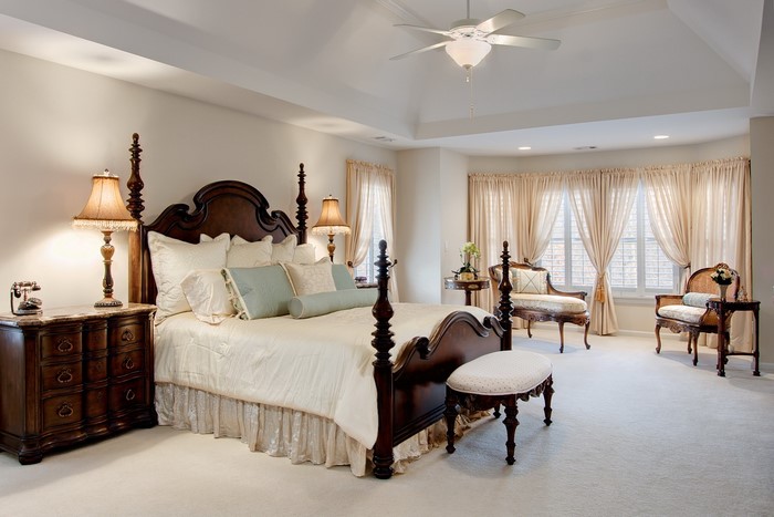 Elegant bedroom with a four-poster bed and bay windows