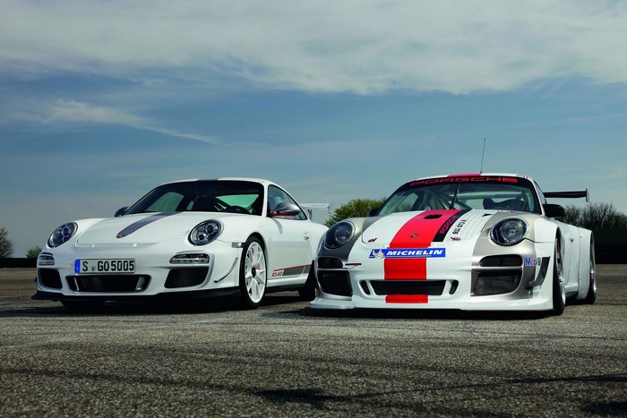 Two Porsche 911 GT3 RS 4.0 cars on asphalt