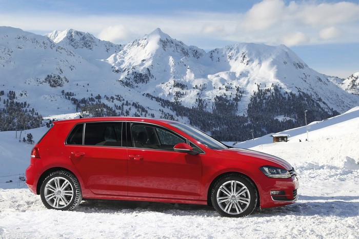 Red Volkswagen Golf VII 4Motion in Snowy Mountains