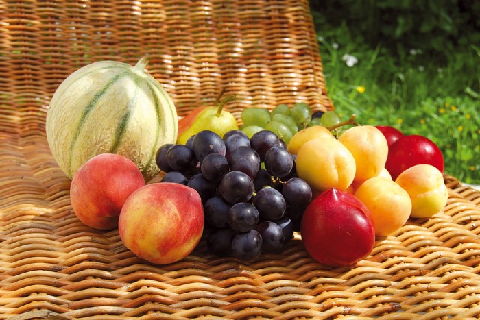 Assortment of fresh fruits on a wicker surface