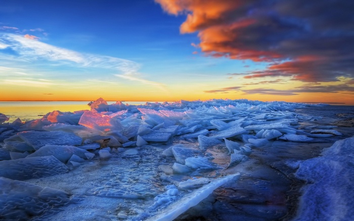 Ice chunks on a frozen shore at sunset