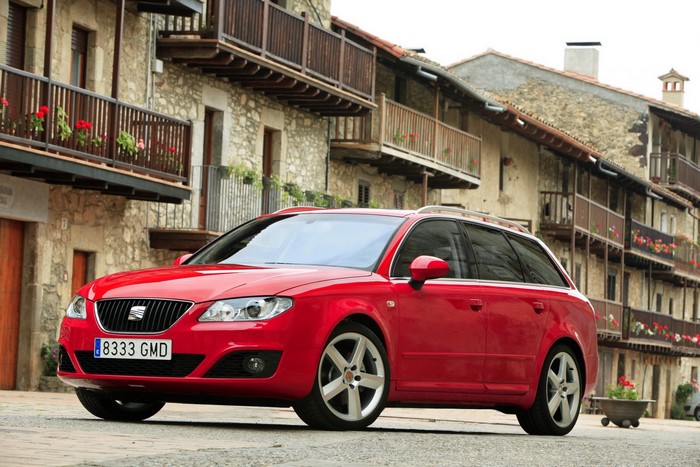 Red 2009 Seat Exeo ST wagon parked in a village