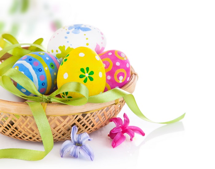 Easter Eggs in a Basket with Ribbon and Flowers