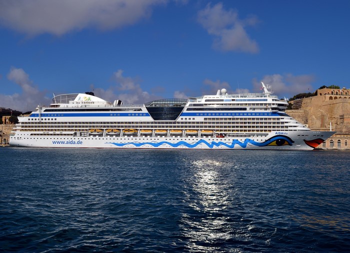 AIDAblu cruise liner sailing near Malta fortifications